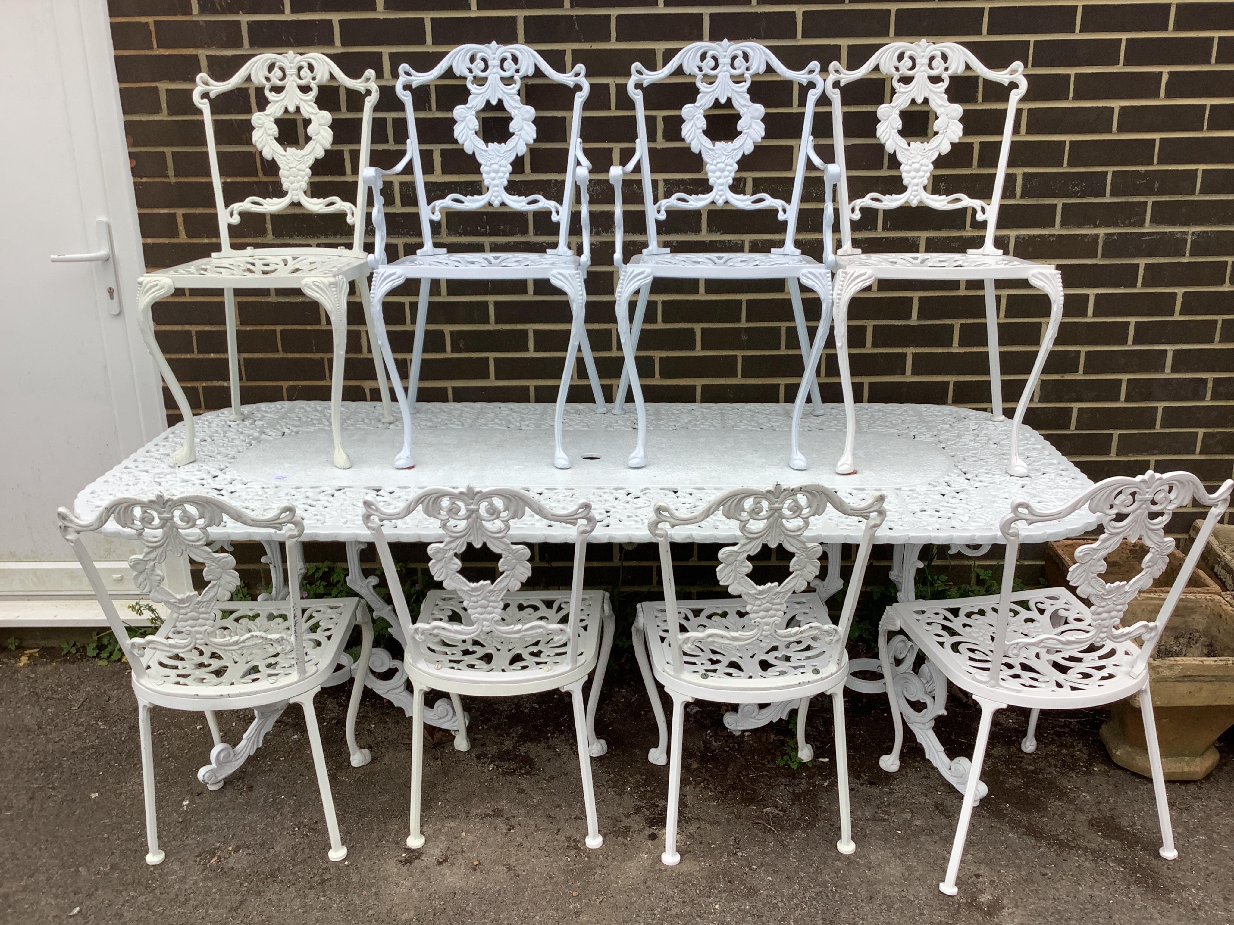 A Victorian style rectangular painted aluminium garden table, width 214cm, depth 90cm, height 74cm and eight chairs (two with arms)